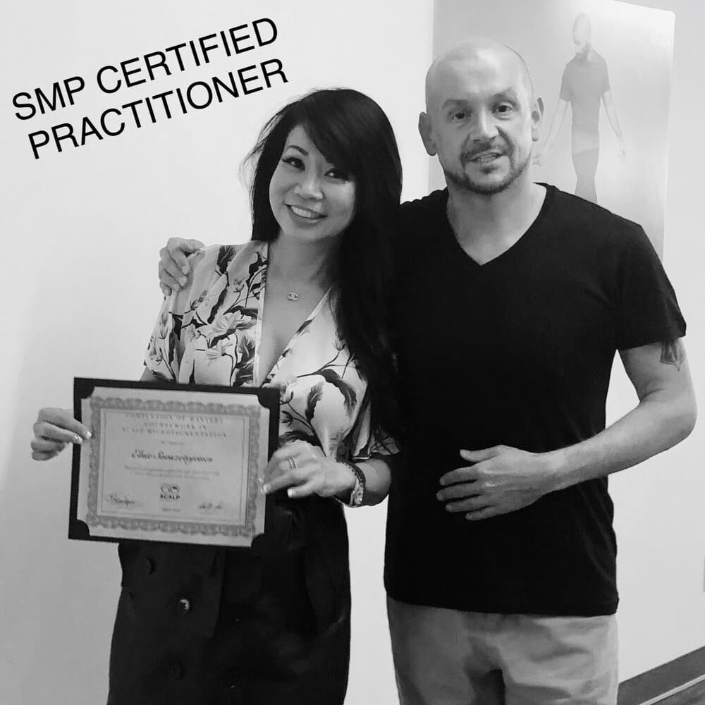 Elsie holding her SMP credentials, Certified Practitioner.